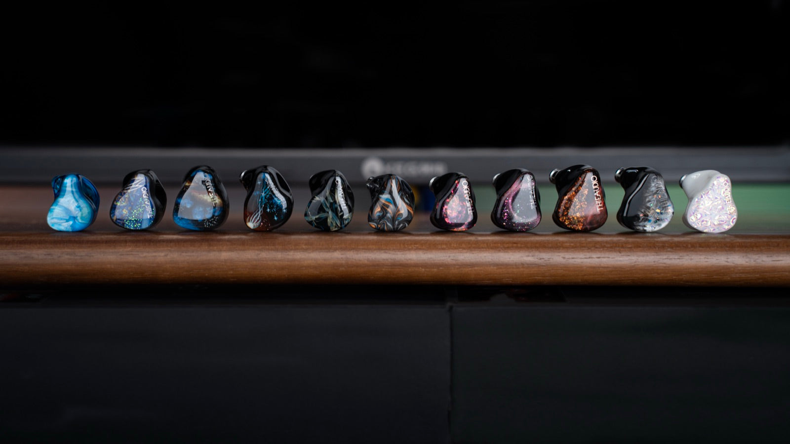 THIEAUDIO in-ear monitors arranged on a shelf